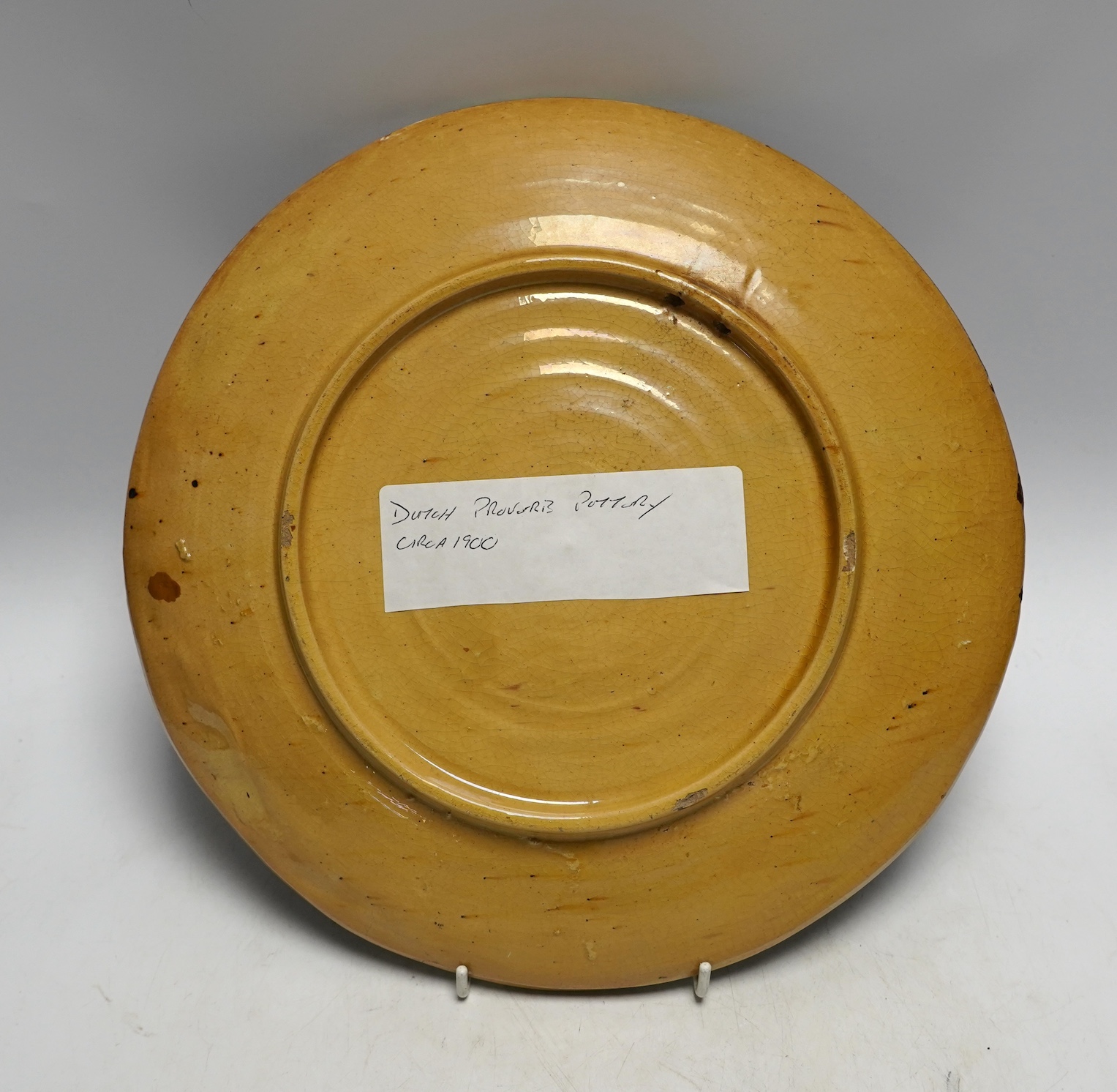 A Dutch pottery proverb plate, circa 1900, 31cm